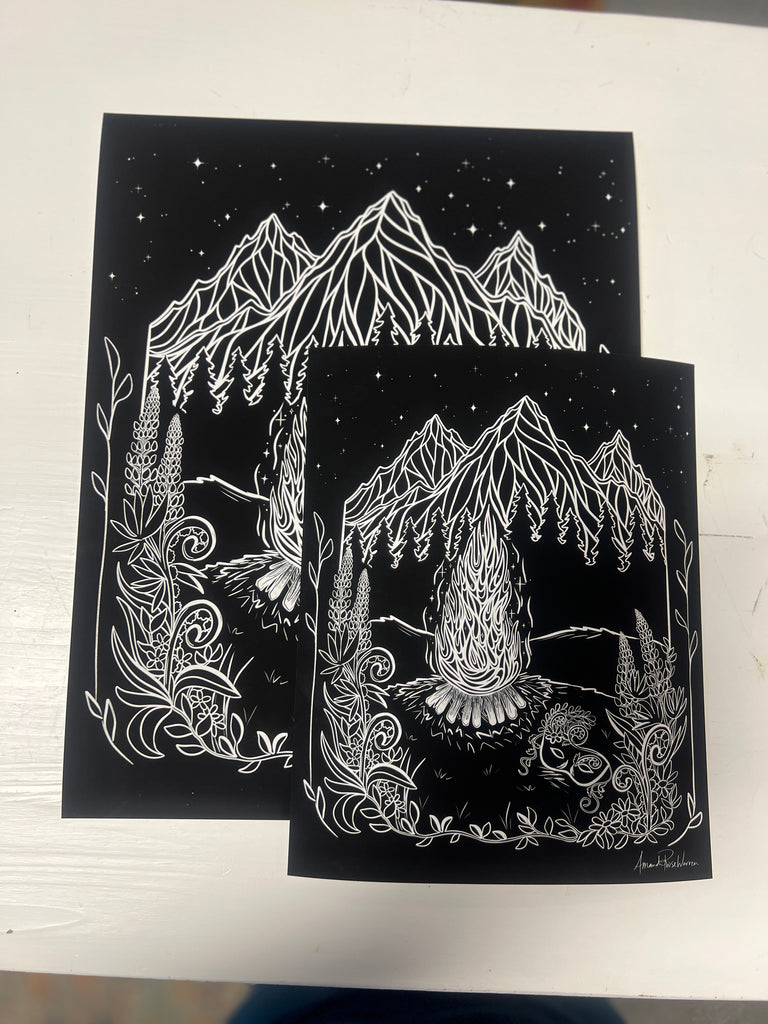 Big and Small sizes of the art print laying on white table