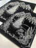 Two Prints laid on top of one another on a table