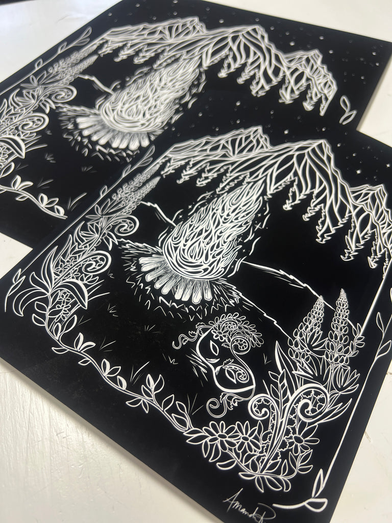 Two Prints laid on top of one another on a table