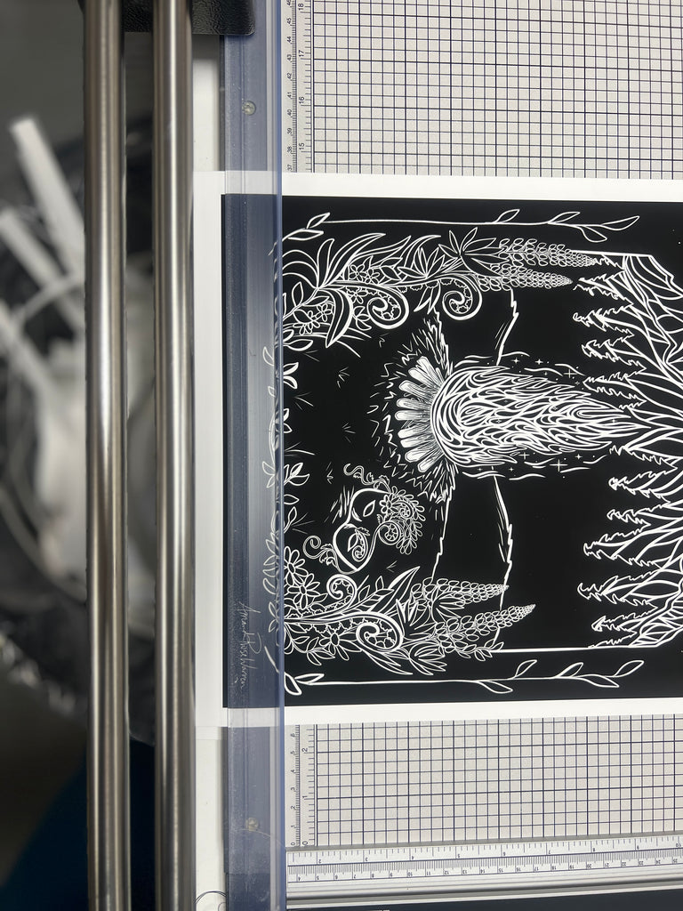 Paper Print with white borders being cut down 