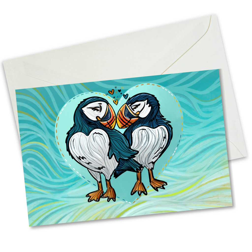 A square greeting card with a white envelope, featuring an illustration of two puffins facing each other inside a heart shape on a turquoise wavy background.