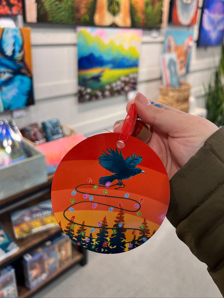 raven carrying lights through a sunset