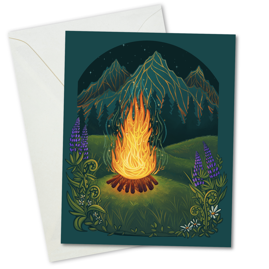 A square art print or card featuring a glowing campfire at night with mountains, green hills, purple flowers, and small white flowers, shown with an off-white envelope behind it on a white background.