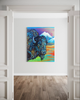 Colorful painting of a bison with mountains on a white wall.