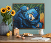 Framed artwork of blue bears on a wall above a wooden table with decorative items.