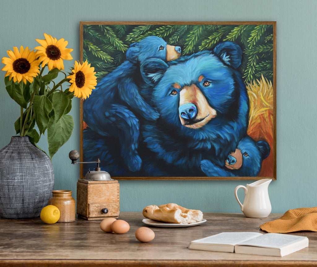 Framed artwork of blue bears on a wall above a wooden table with decorative items.