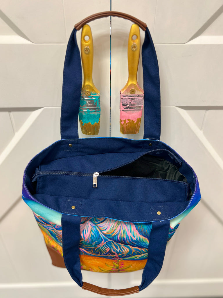 Canvas tote bag with Sunlit Denali design, Alaska mountain artwork with warm sunlight, finished with leather accents and zipper closure