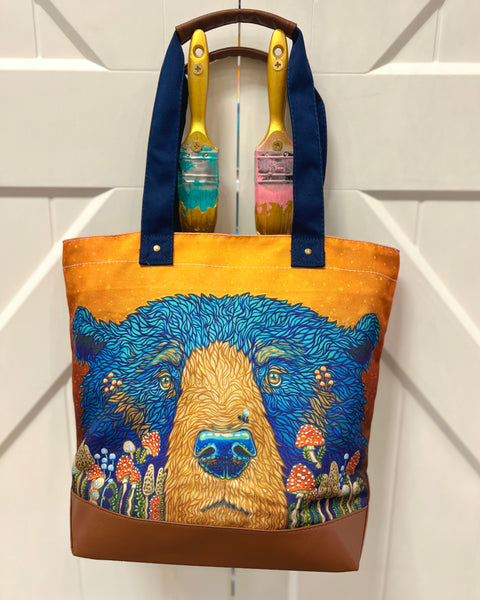 Fun Guy Bear canvas tote bag with leather accents and zipper, featuring Alaska bear design with playful mushroom-inspired artwork