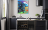 Modern kitchen with a colorful painting of a bison on the wall.
