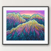 Framed artwork of colorful mountain landscape on a white wall