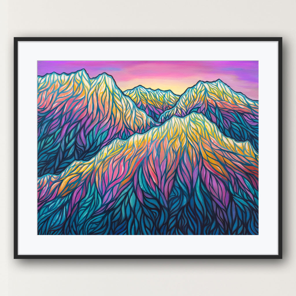 Framed artwork of colorful mountain landscape on a white wall