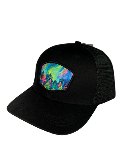 Mystic Trees black trucker hat featuring Alaska forest design with colorful trees, adjustable mesh cap with bold artistic woodland style