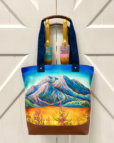 Sunlit Denali canvas tote bag with leather accents and zipper, featuring Alaska mountain landscape with warm glowing light