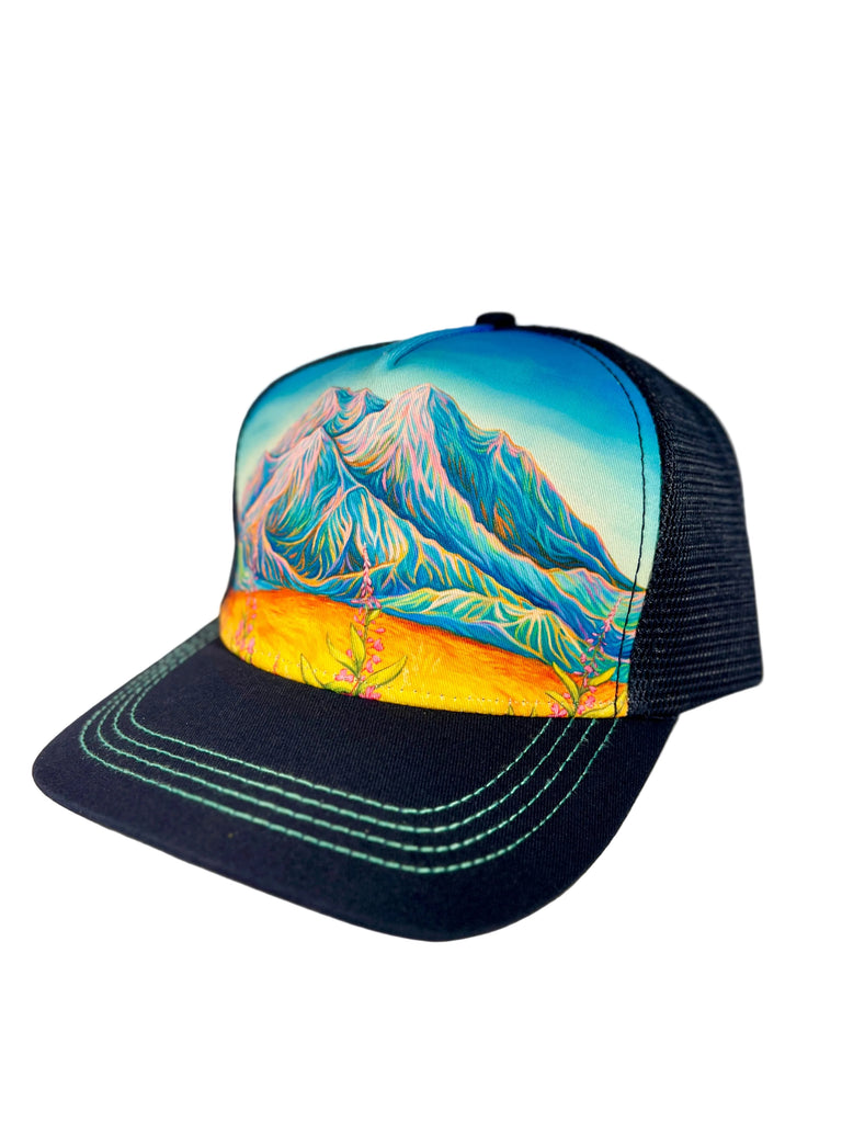Sunlit Denali navy trucker hat featuring Alaska mountain landscape with warm sunlight, adjustable mesh cap with scenic nature design