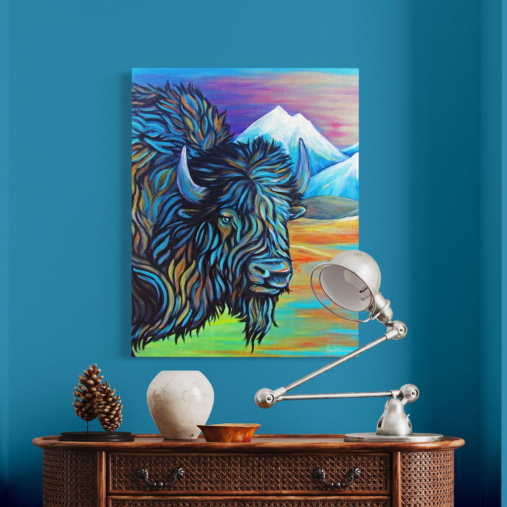 Colorful painting of a bison on a blue wall above a wooden console table with decorative items.