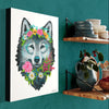 Canvas print of a wolf with floral decorations on a teal wall next to a wooden shelf.