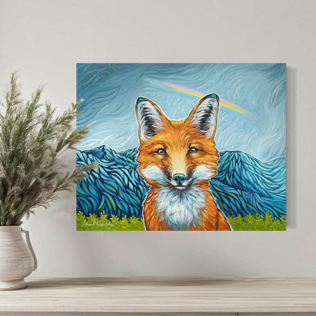 Canvas print of a fox with mountains in the background on a wall above a shelf.