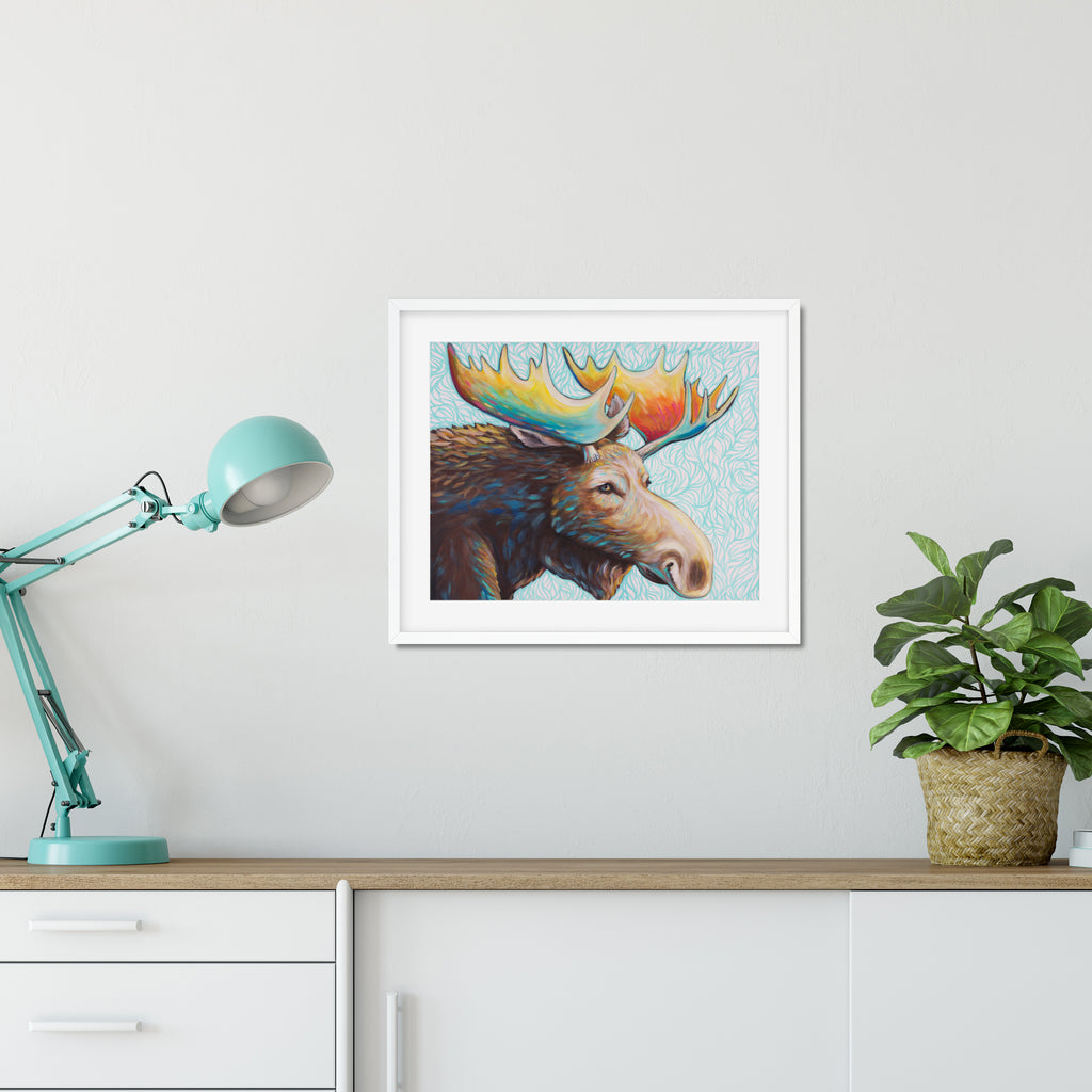 Framed Alaskan Bull Moose, a vibrant rack with a teal background hanging on office wall 