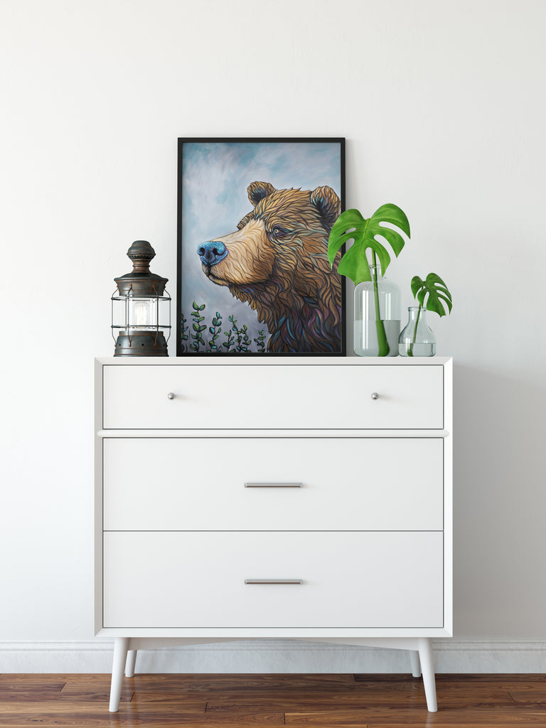 Framed Alaskan Brown Bear with a pop of color in his fur sitting on a white dresser