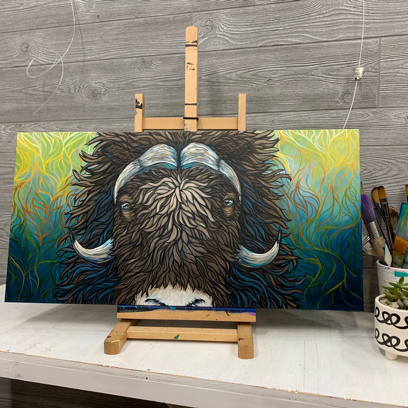 Alaskan Musk Ox with a unique fading yellow to teal background resting on an easel 