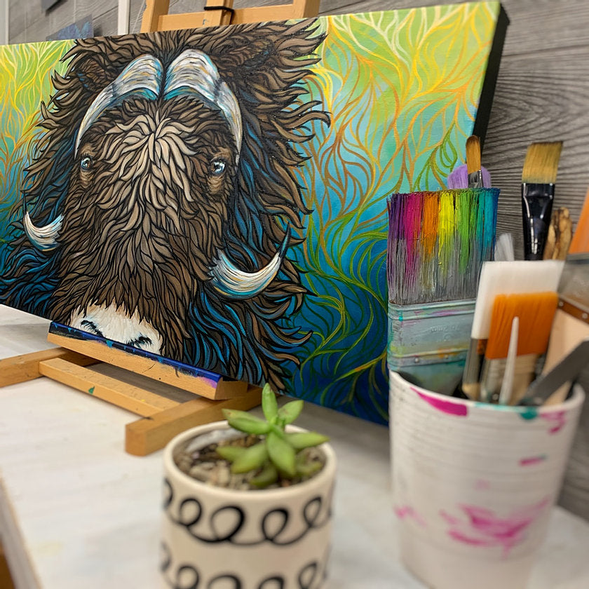 Alaskan Musk Ox with a unique fading yellow to teal background resting on an easel 